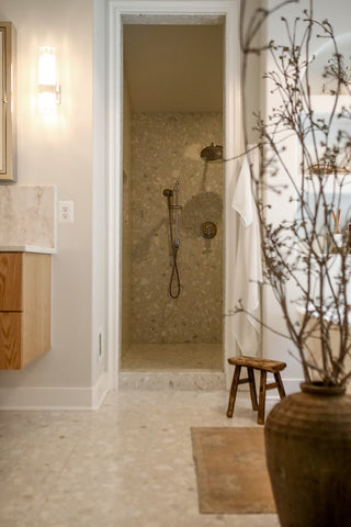 Peering into a stepless shower with natural textures layered throughout the design.