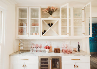 A kitchen bar designed with a wine cooler and display cabinet.