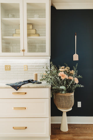 A kitchen with a dark accent wall, a modern home design idea.