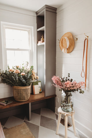 A crisp, clean mudroom design with pink flower accents.