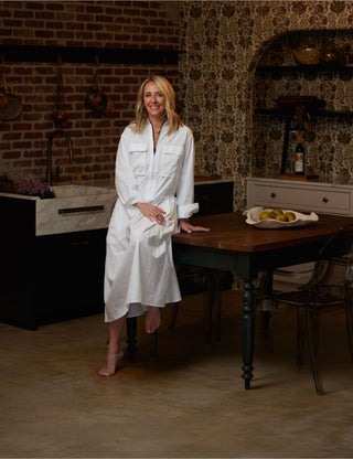 Amanda Chando sitting on furniture for sale at the Annapolis interior design showroom