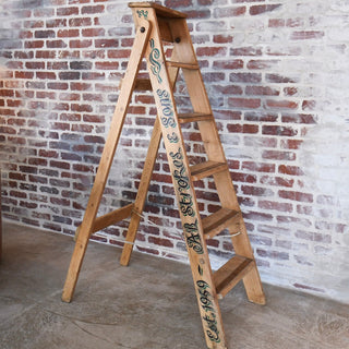 Antique Wooden Ladder used as a blanket display in a rustic living room