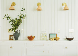 White cabinets with gold hardware for a clean and bright effect.