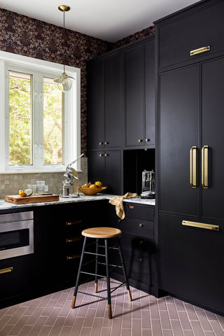A bold modern house interior with cabinets painted in dark colors.