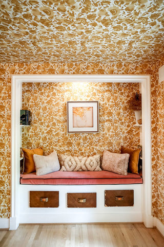 Flowered wallpaper on the walls and ceiling of a bold kids bedroom design.