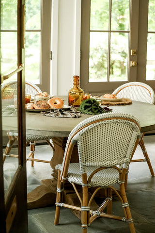 A kitchen table with wicker chairs
