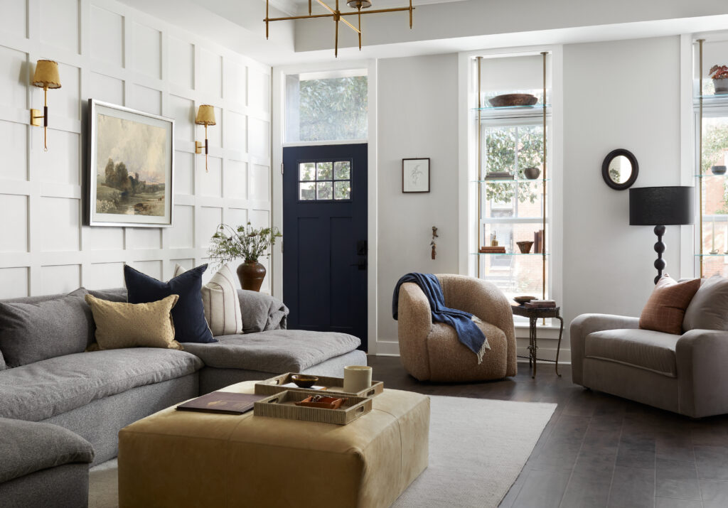 Details + Design living room featuring layered blue coastal interior design with navy door, warm neutrals, and cream tones.