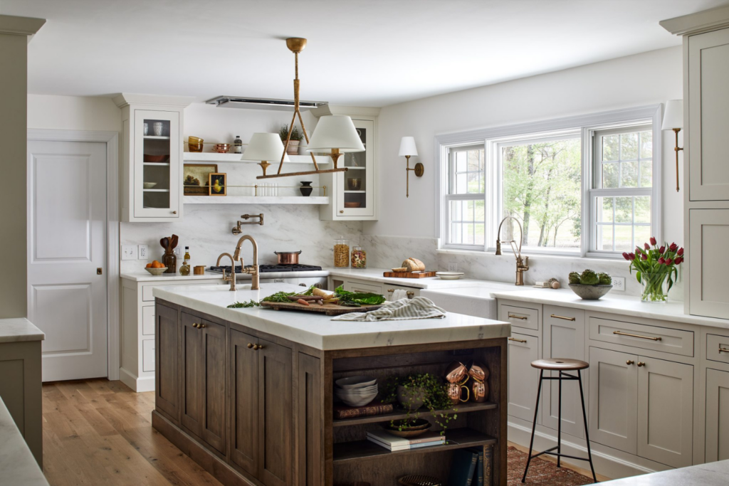 Interior design return on investment highlighted in a bright neutral kitchen with wood island cabinetry, open shelving, and classic transitional finishes.